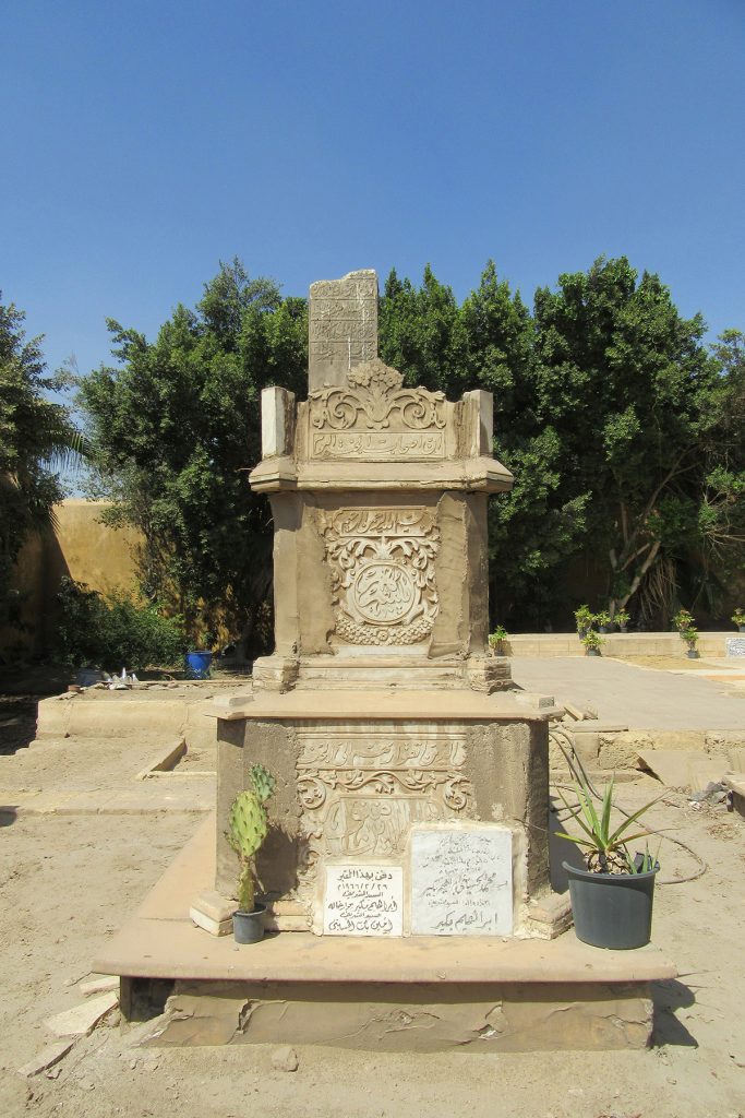 Damaged marble cenotaph, S side