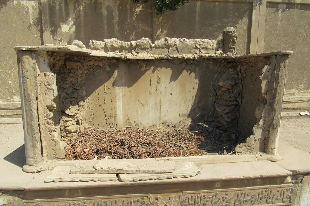 Seriously damaged marble cenotaph, looking E