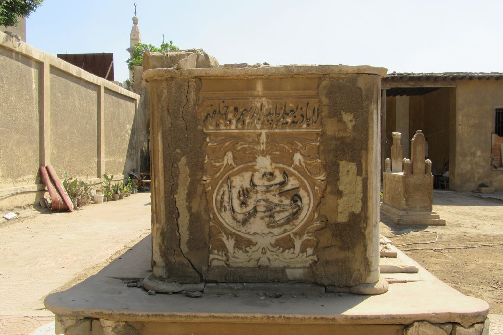 Partially damaged marble cenotaph, looking S